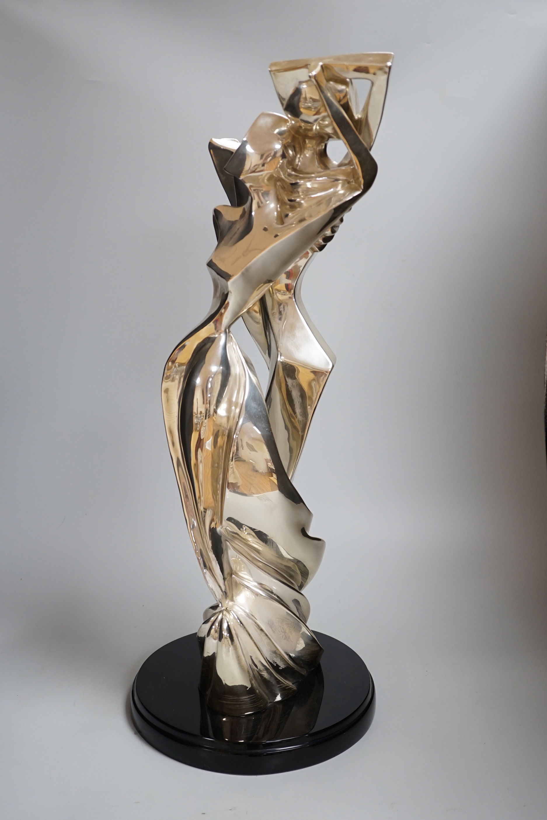 A plated abstract figural sculpture on stand, signed Geris, 45/500, 59cm